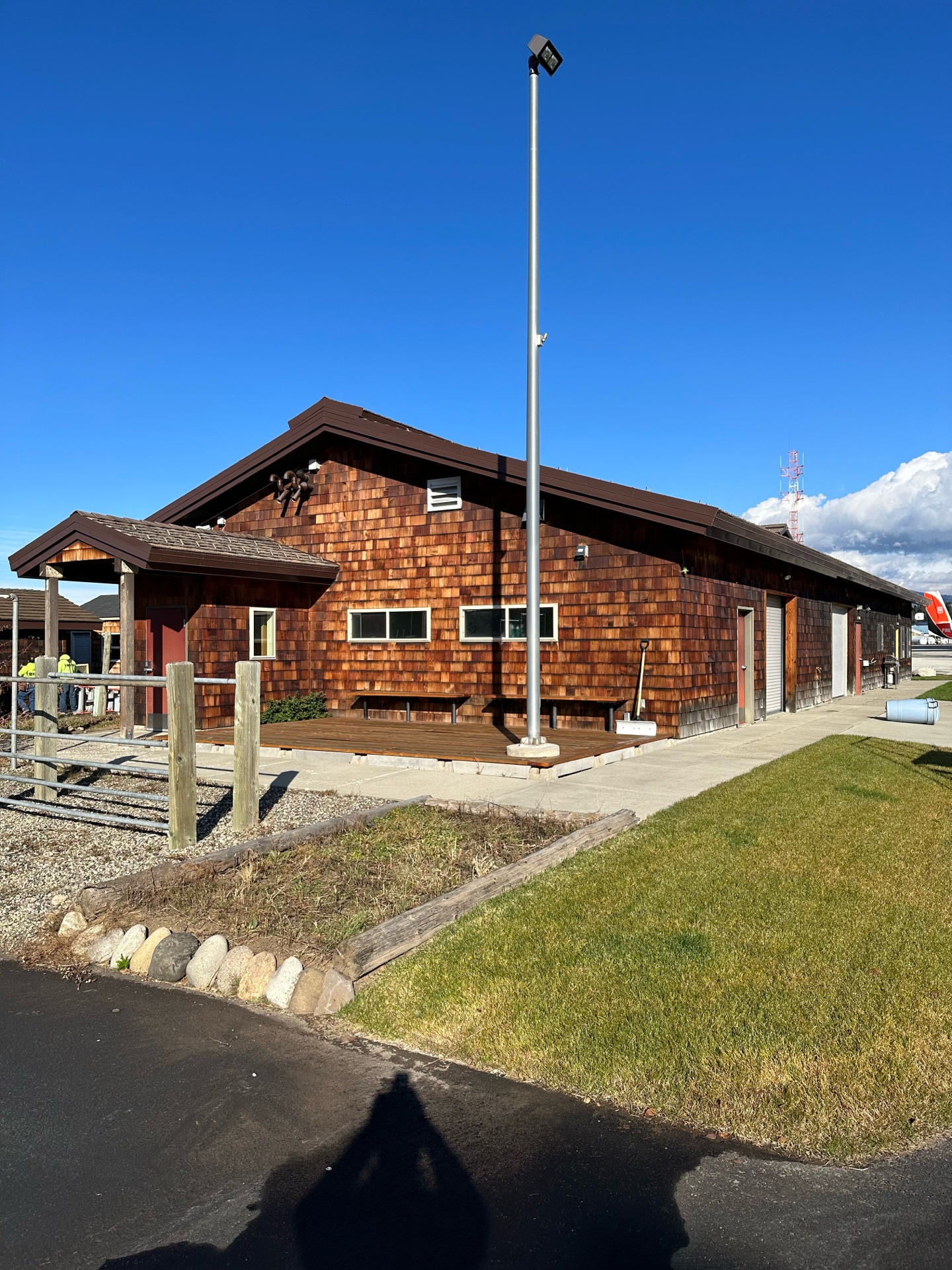 After photo of McCall Smoke Jumper Base outbuilding — fully completed new cedar shake siding with clean trim and new deck
