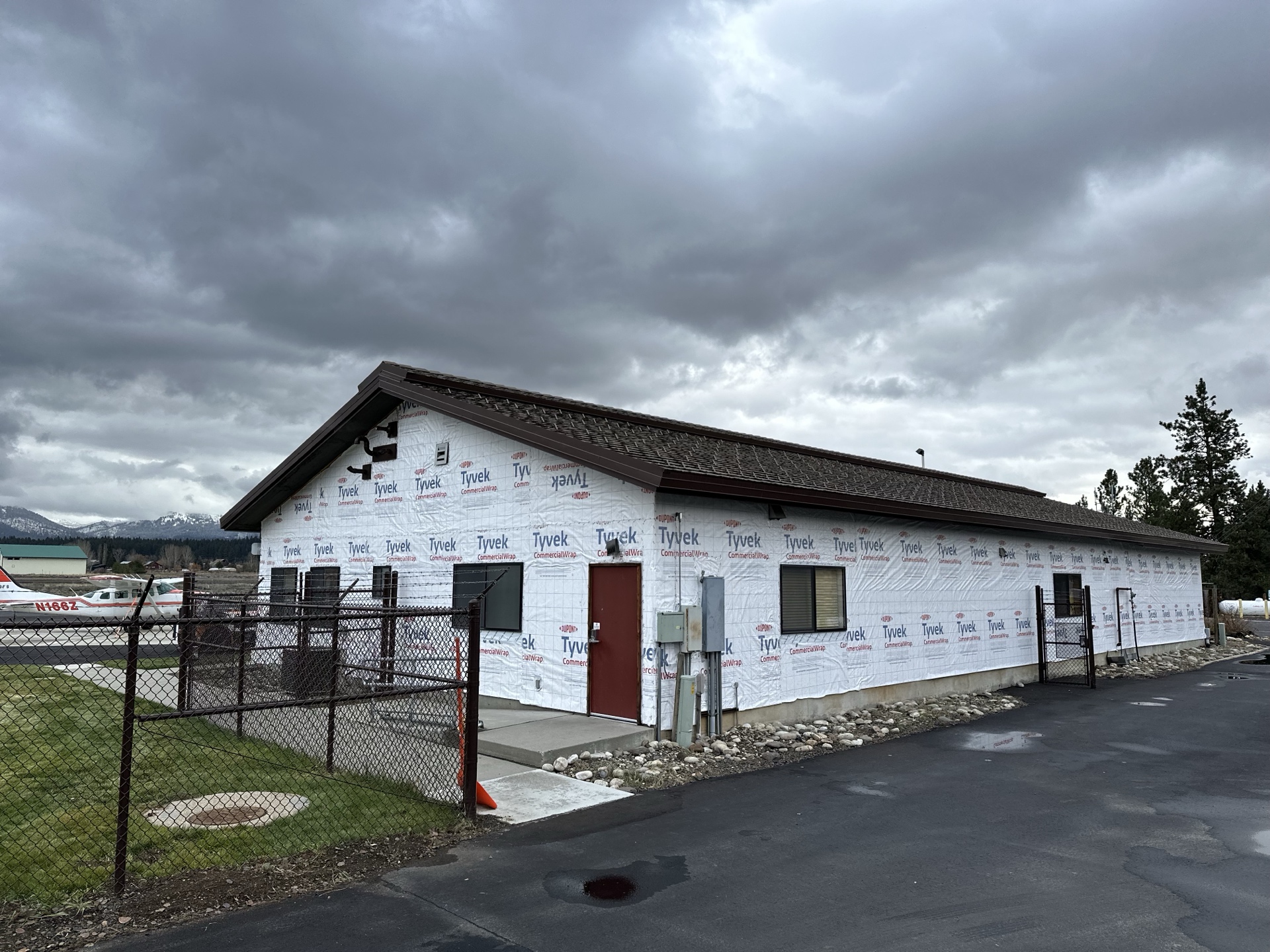 Before photo of McCall Smoke Jumper Base main building wrapped in Tyvek CommercialWrap, ready for new siding