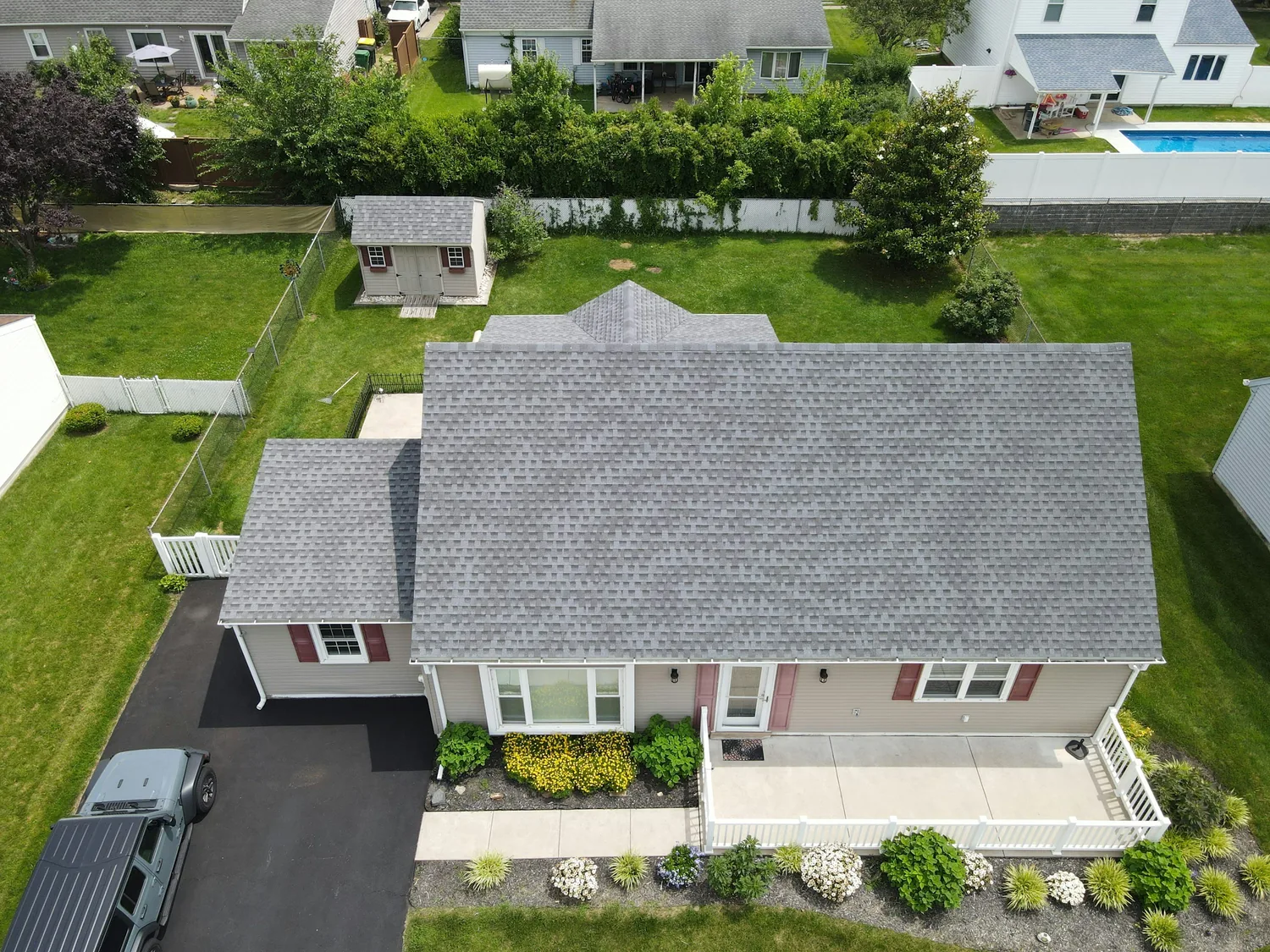 Clean residential roof with refreshed shingles after roof replacement