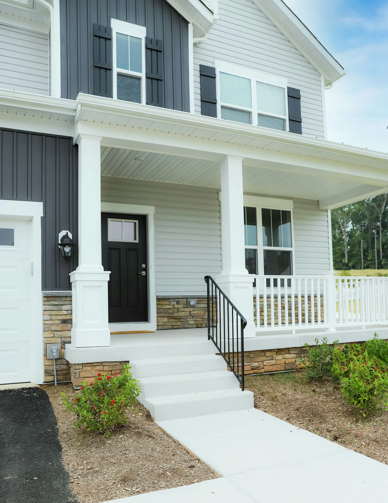 Refreshed front exterior with clean windows, siding, trim, and porch details