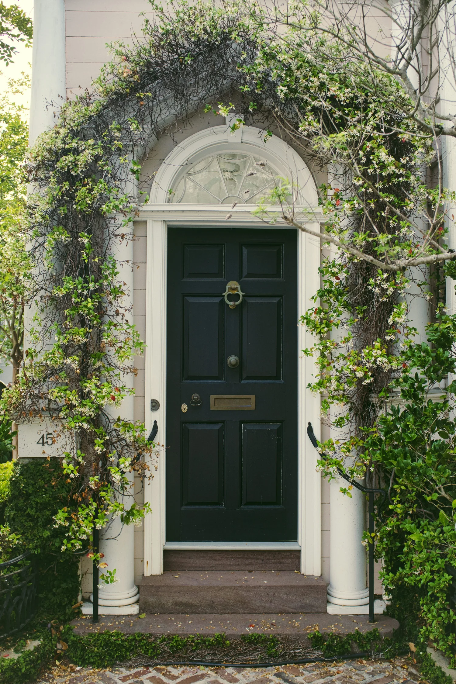 Refreshed front entry door with coordinated surround and hardware after replacement
