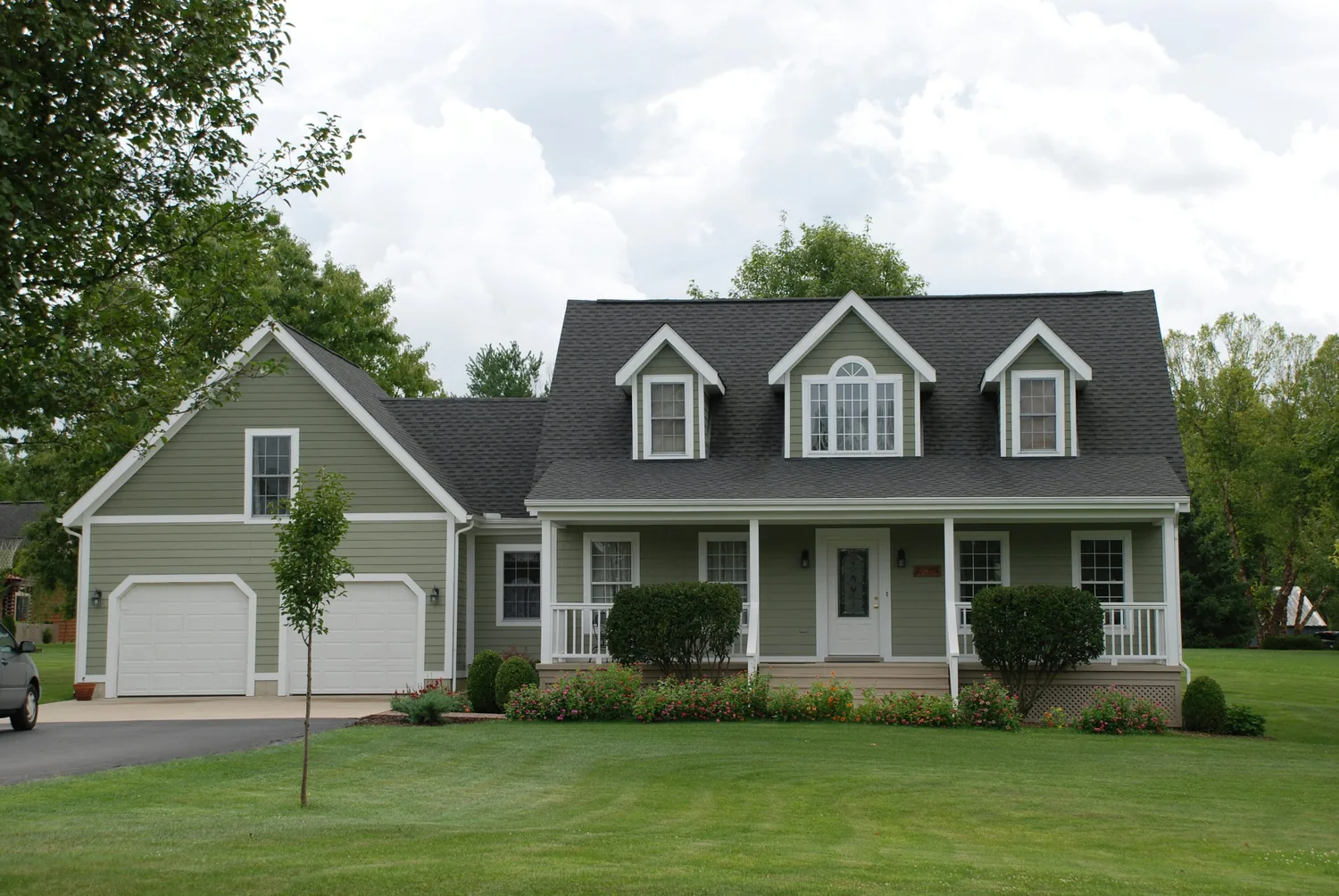Fresh exterior with clean gray siding and coordinated roof after exterior improvements