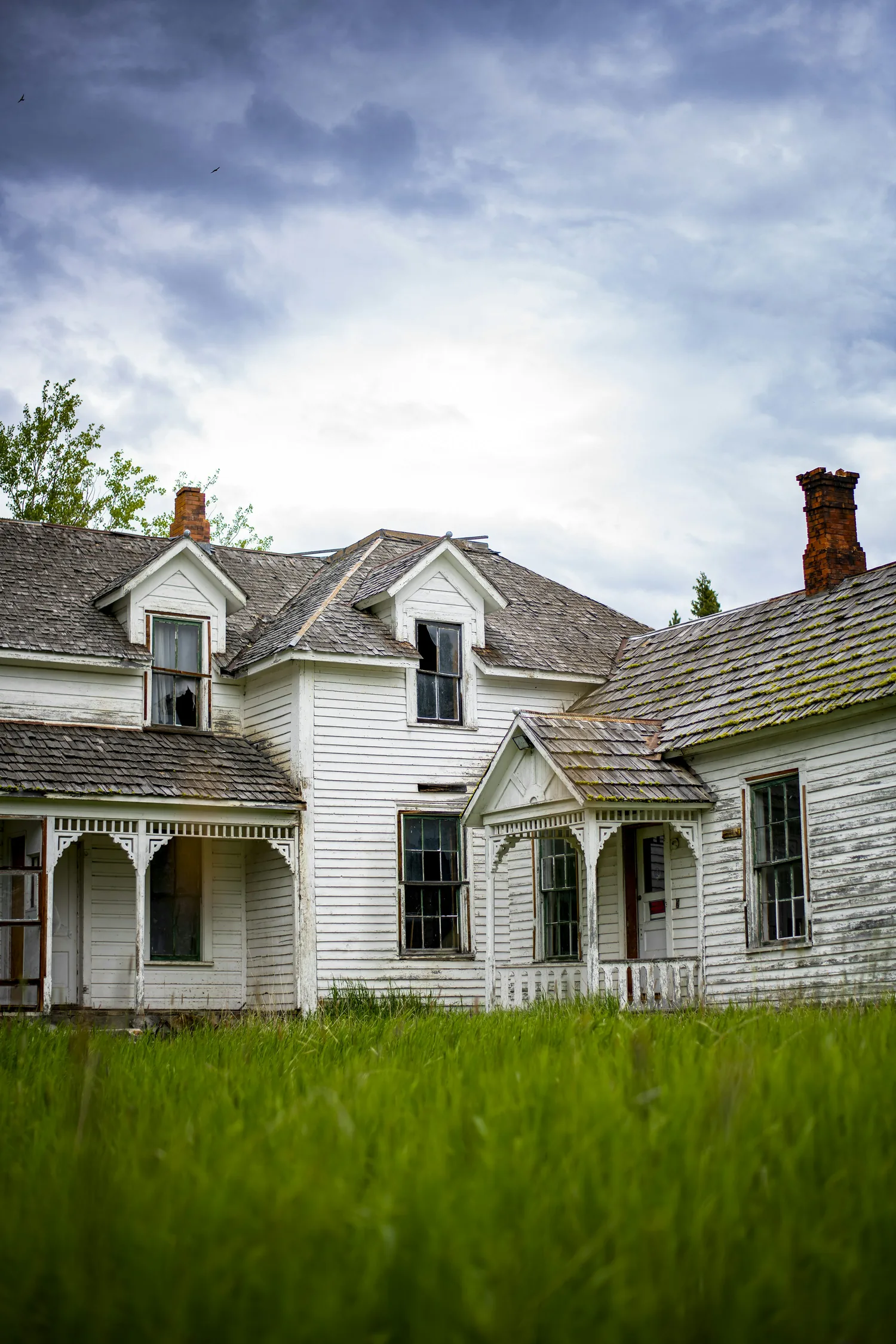 Older home facade with dated windows and trim before replacement planning