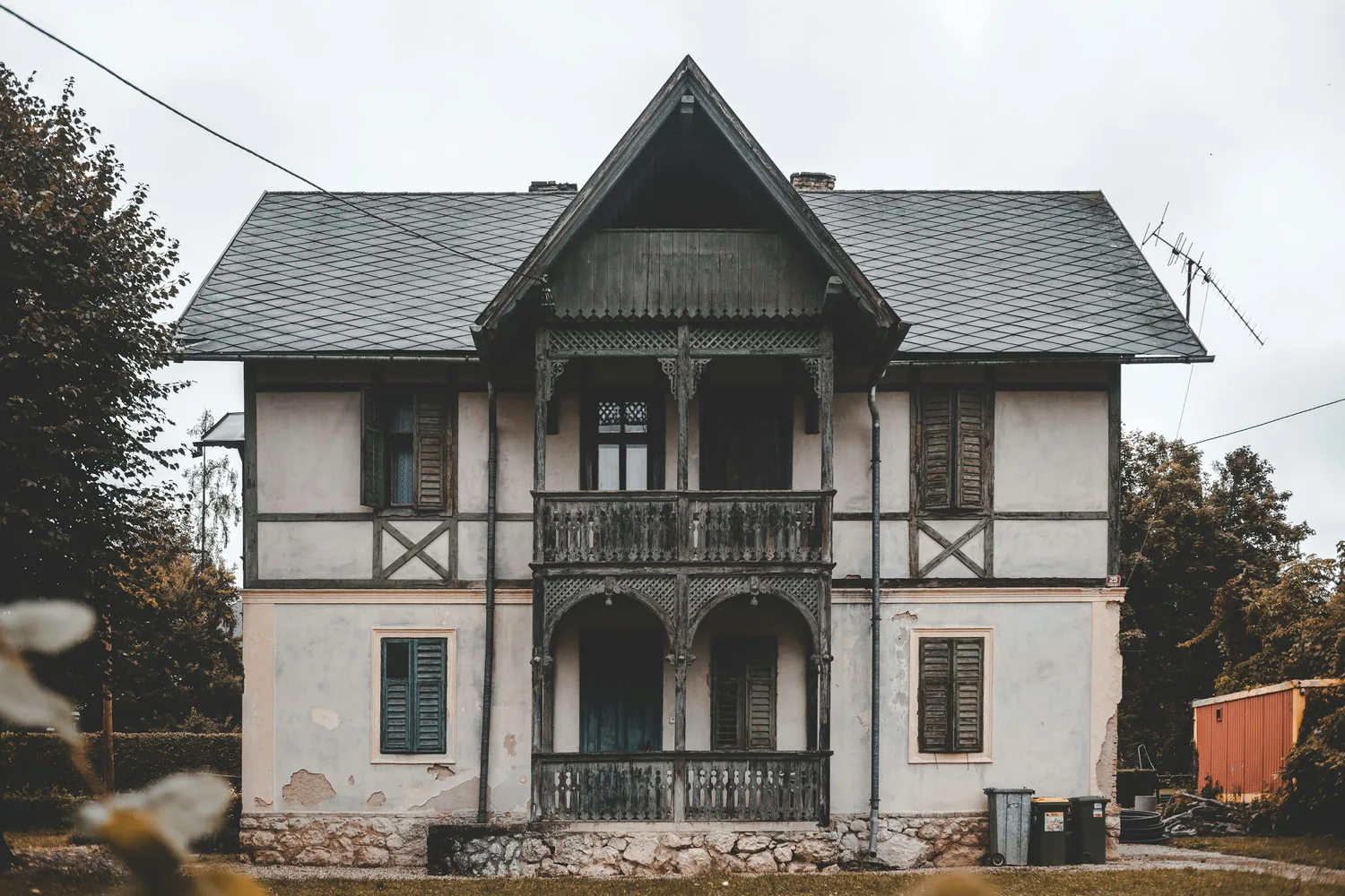 Older exterior with aging window openings before replacement planning